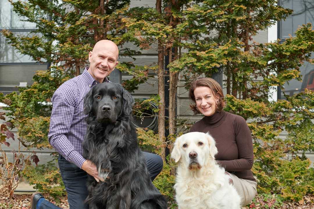 Brian and Beth posing with their two dogs